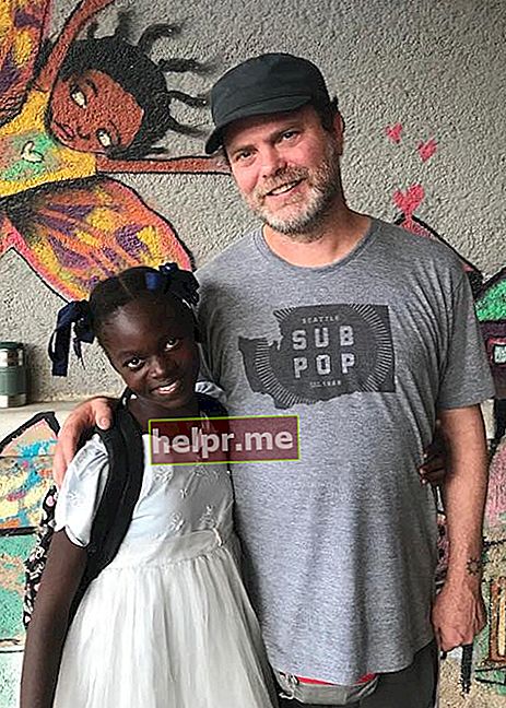 Rainn Wilson نومبر 2017 میں Gonaïves، Haiti میں BSEIPH معذور پروگرام سے یوسیمیکا نامی بچے کے ساتھ